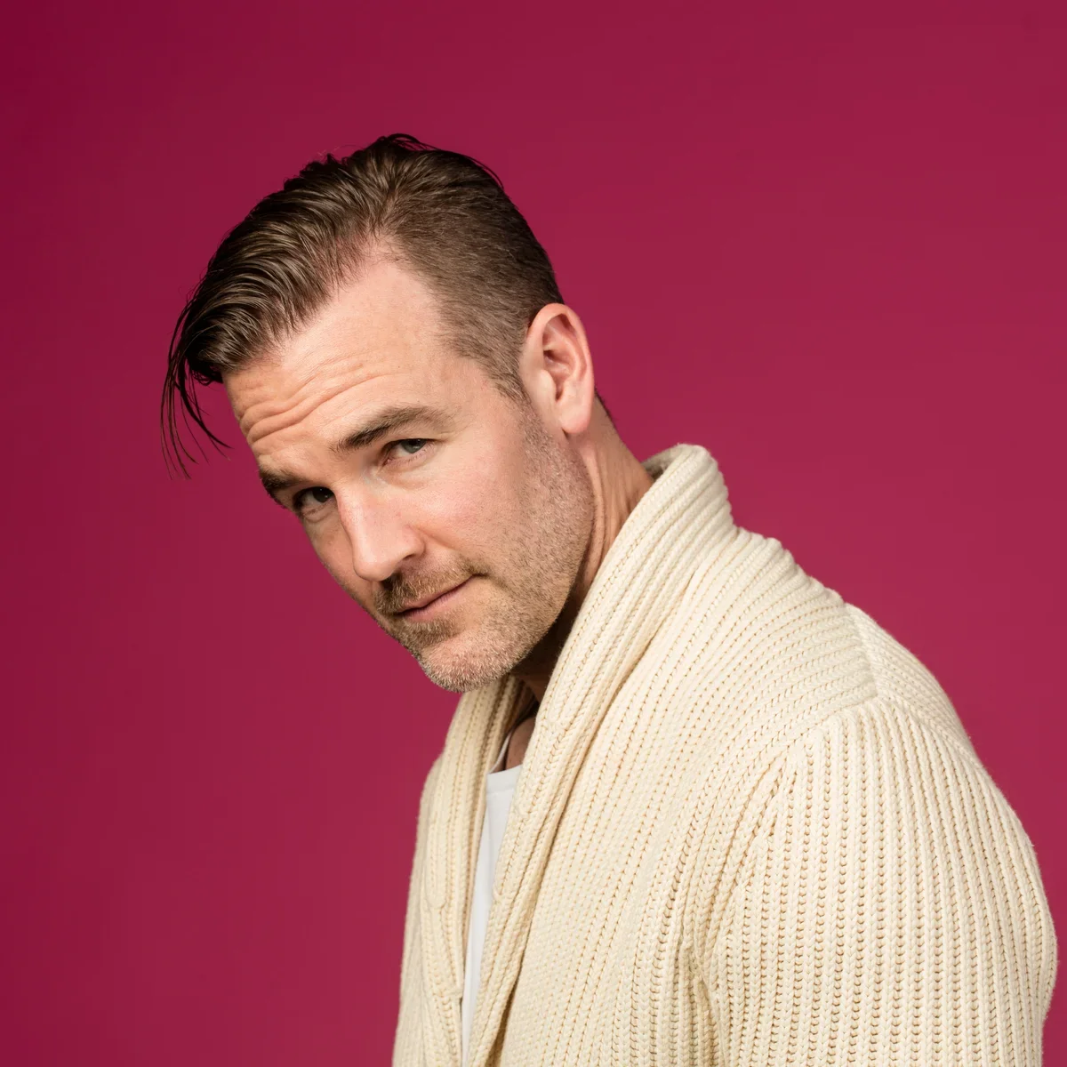 Ο James Van Der Beek σε πορτρέτο από το πλάι, με ροζ φόντο